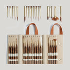A collection of paint brushes with wooden handles and synthetic bristles, displayed in various sizes and shapes, accompanied by a leather-look carrying case.