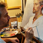 Artist painting a portrait with a palette and brushes in the foreground